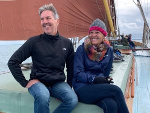 A photo of a man and a woman sitting on a boat and smiling